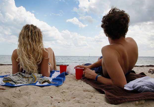 a couple in the shade at the beach