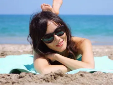 female wearing sunglasses on the beach